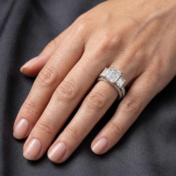 Elegant Three-Stone Emerald Cut Diamond Ring with Pavé Band in Two-Tone Gold